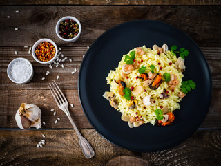 Risotto with seafood on wooden background