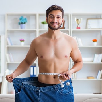 Man in oversized pants in weight loss concept