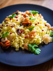 Risotto with seafood on wooden background