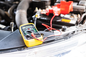 Close up of multimeter for checking the voltage level in a car battery.