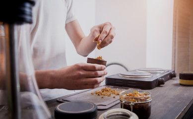 Cooking hookah in the bar. Cutting tobacco into a bowl. Restaurant, hookah bar, smoking cafe.