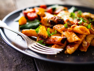 Pasta casserole with barbecue chicken breast, cheese and vegetables
