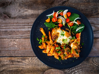 Pasta casserole with barbecue chicken breast, cheese and vegetables