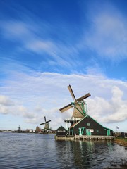Zaanse Schans is the most beautiful village of netherlands people is coming from all over the world to admire the windmills that are now houses or museums the green fields and the tulips 