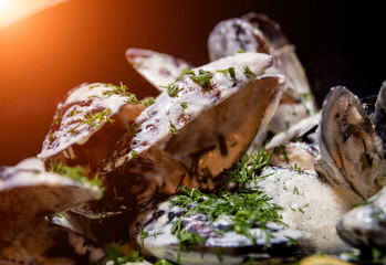 Mussels with garlic white sauce in a bowl. Restaurant