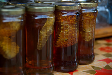 Brown honey in glass bottle