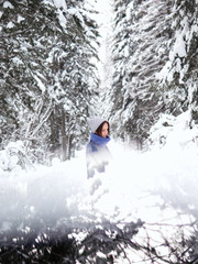 A brunette walks through the winter forest. 