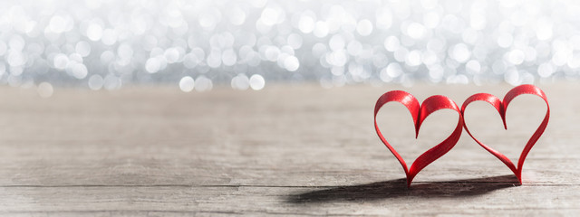 Red ribbon hearts on glitters