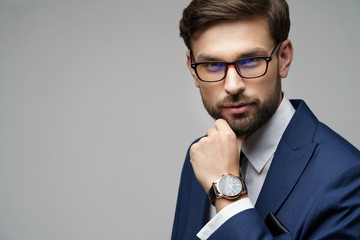 Studuo shot of thinking businessman wearing suit