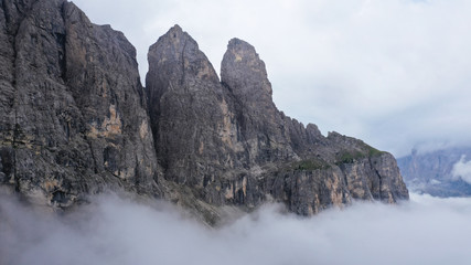 Fototapeta na wymiar Aerial view of Dolomites Alpine mountains in fog and low clouds. South Tyrol, Italy.