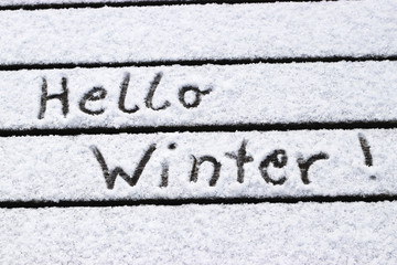Hello Winter, written on snow covered planks