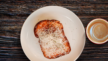 Toast Bread with Cheese on White Plate with Hot Coffee Latte. Morning Meal on Cozy Weekend.Top View
