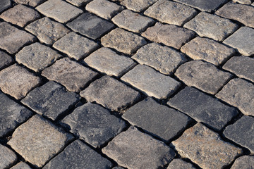 Paving stones of large stones lit by the sun, texture