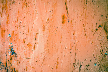 Old rough wall texture for background.  Wallpaper with vintage or retro colors.  Dark orange background