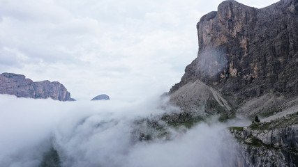 Fototapeta na wymiar Aerial view of Dolomites Alpine mountains in fog and low clouds. South Tyrol, Italy.