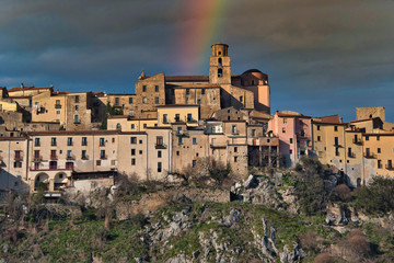Fototapeta na wymiar Rainbow over a Hilltop Village in Southern Italy