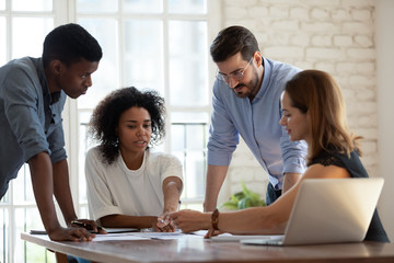 Diverse business team working together, discussing project documents