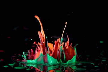 Zelfklevend Fotobehang Color paint splash on a black background © luchschenF