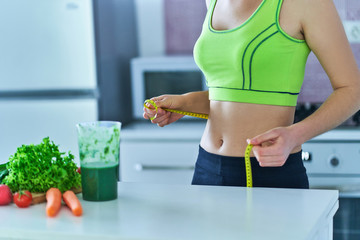 Diet woman with a green smoothie for losing weight. Vegetables detox organic fitness drinks for...