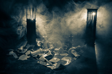 Chess figures on a dark background with smoke and fog. Selective focus