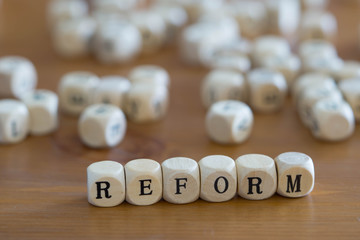 Reform written with wooden cubes