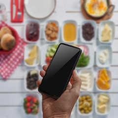 Cellphone screen detail on the man hand and interior background