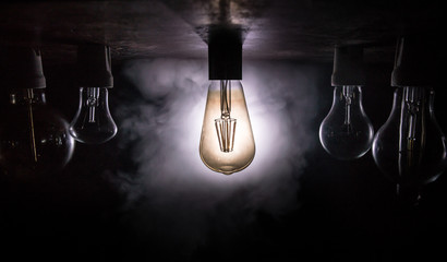 Abstract dark background with creative artwork decoration of glowing bulbs.