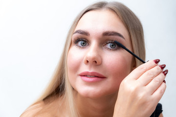 Beauty Cosmetics. Closeup Of Beautiful Sexy Woman Putting Black Mascara On Long Thick Eyelashes With Brush. Fashionable Female Model With Soft Skin, Perfect Makeup And Fake Eyelashes. High Resolution.