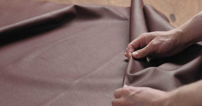 Man Hand Checking Brown Leather Piece Closeup