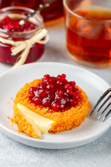 Baked or fried (grilled Camembert or brie cheese with cranberry (lingonberry, cowberry) sauce or...