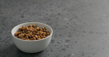 dried seaberry in white bowl on terrazzo countertop