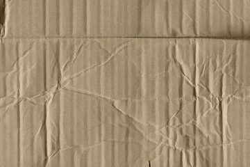 Close up grainy decorative light brown vintage rough sheet of carton. Cardboard paper texture blank background. Brown color old pattern empty papercraft surface. Recycled ecology friendly material.