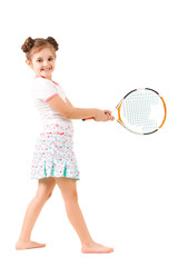 Naklejka na ściany i meble Small positive girl in stylish clothing standing and holding tennis racket in hand and smiling over white background