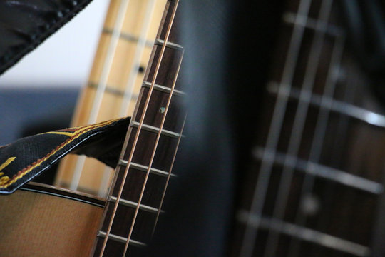Instruments - acoustic guitar sharp close-up with guitar belts. Hi-res stock image