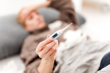 Woman sick in the bed, flu and virus infections, allergy, seasonal healt issues.