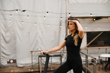 Fit Woman stands with electric scooter, rides away - Shot of Modern transportation gadget and popular futuristic device among young people - Eastern European Latvia Riga