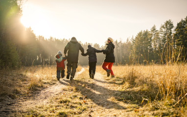happy family walking on country road	