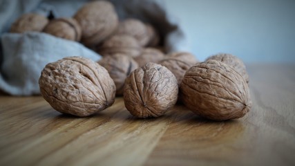 unpeeled walnuts in a gray canvas bag