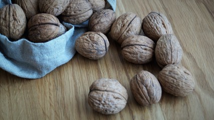 unpeeled walnuts in a gray canvas bag