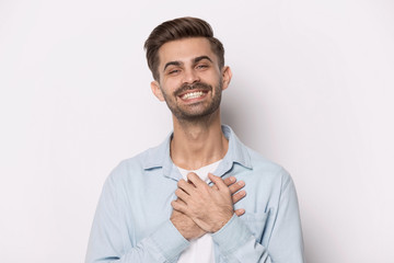 Happy thankful smiling young man feeling grateful.