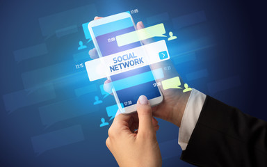 Female hand typing on smartphone with SOCIAL NETWORK inscription, social networking concept