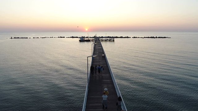 Wooden Dock Extending Into Tropical  Sea at Sunrise. Aerial Shot