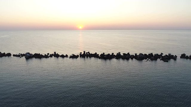 Wooden Dock Extending Into Tropical  Sea at Sunrise. Aerial Shot