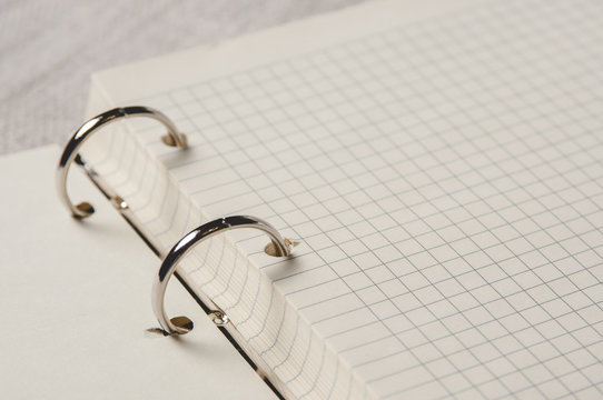 Notebook with pages in a cell. Blank page of open notebook