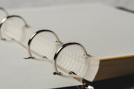 Notebook with pages in a cell. Blank page of open notebook