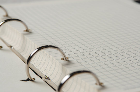 Notebook with pages in a cell. Blank page of open notebook