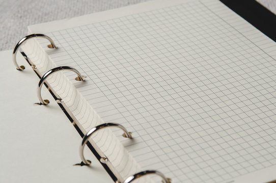 Notebook with pages in a cell. Blank page of open notebook