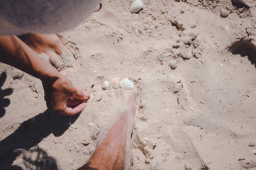 Feet on a white sand beach