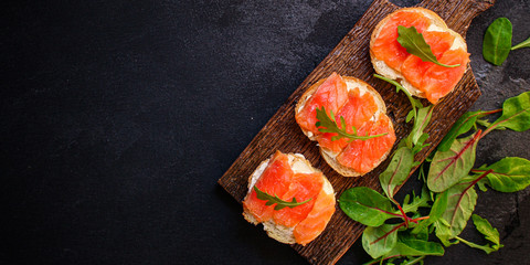 sandwich salmon smorrebrod (delicious snack seafood fish) menu concept. food background. top view. copy space