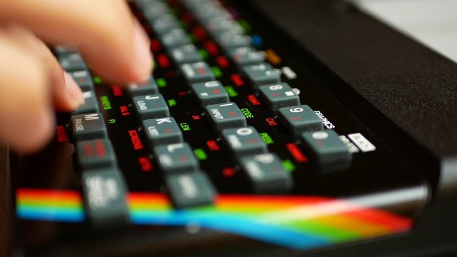 Man's hand typing on an old computer